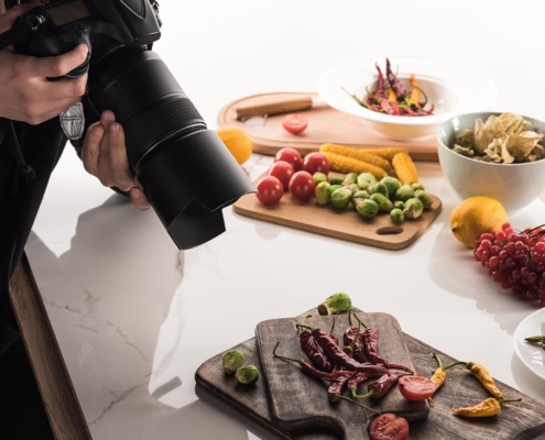 Professional photographer taking photos of displayed food