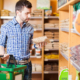 Young man reading a product label