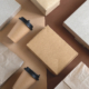 top view flat lay disposable blank delivery food packaging on a beige and brown background